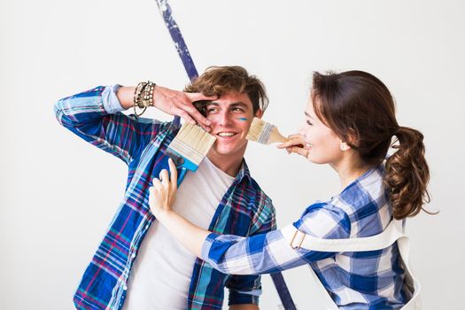 Teamwork, renovation and repair concept - Portrait of funny couple doing redecoration in apartment.