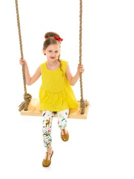 Happy little girl gaily swinging on a swing. The concept of a summer vacation in nature, a family vacation with the family on the beach or the sea. Isolated on white background.