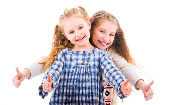 Two girls laughing and showing thumbs up, ok gesture and looking at camera isolated on white background