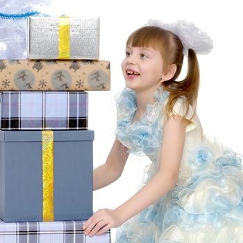 Beautiful little girl with a gift on a white background. Concept of a holiday, New Year and Christmas. Isolated.