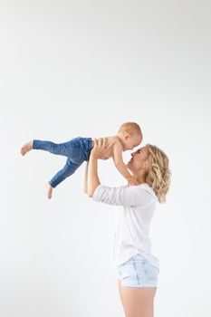 Happy mother with adorable baby on white background.