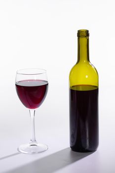 Red wine bottle pour glass on white background.