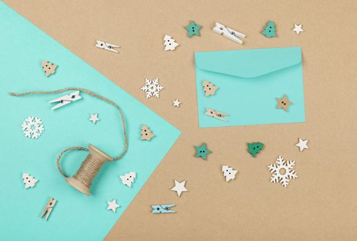 Close up packing and wrapping Christmas gifts with blue and brown paper, table top view, flat lay
