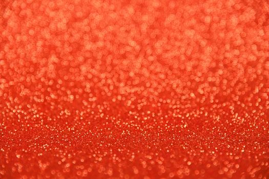 Abstract background of red bokeh defocused blurred lights and glitter sparkles