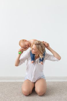 Children and single parent concept - mother playing with her baby