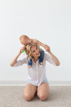 Cute single mother and kid girl playing together indoor at home.