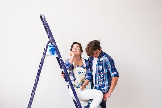 People, renovation and repair concept - Portrait of lovely couple doing redecoration in apartment.