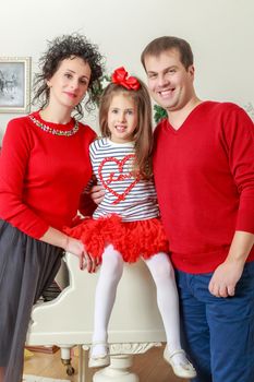 Happy parents with little daughter in a relaxed family atmosphere in the New year.