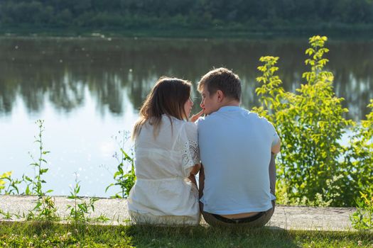 Young couple in love outdoor.Stunning sensual outdoor portrait of young stylish fashion couple posing in summer.