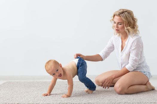 Family and childhood concept - Portrait of mother and baby playing and smiling at home