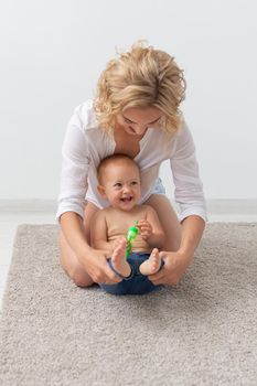 Children and single parent concept - mother playing with her baby