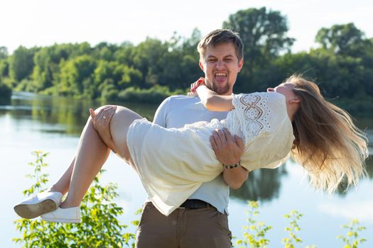 Young couple in love outdoor.Stunning sensual outdoor portrait of young stylish fashion couple posing in summer.