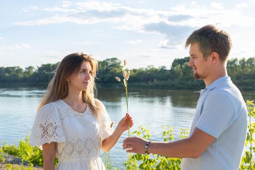 Joke, relationship and humor concept - Portrait of a funny love couple fooling around on nature.