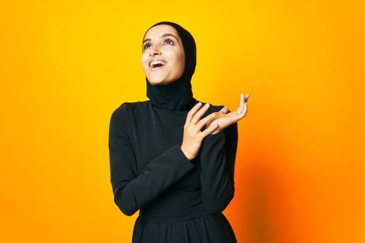 pretty woman happiness fashion clothing hand gesture yellow background. High quality photo
