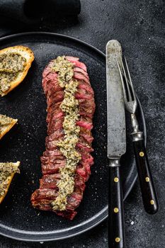 Grilled denver marble black angus beef steak. Black background. Top view.