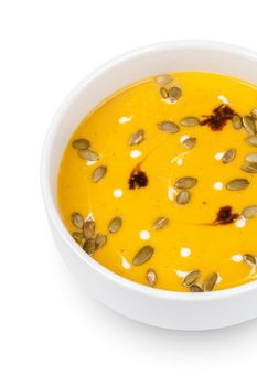 Bowl of pumpkin soup isolated on white background