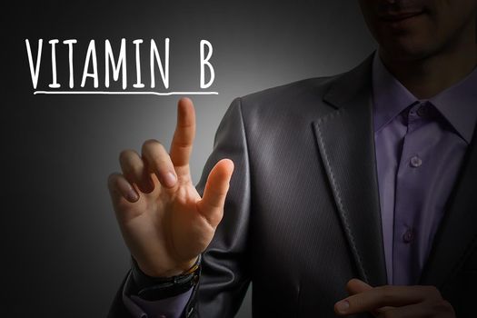 businessman's hand shows vitamin b