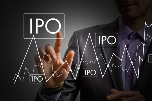 Businessman hand touching IPO or Initial Public Offering sign on virtual screen
