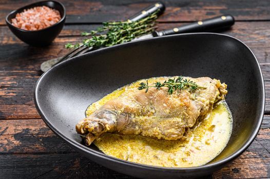 Stew with hare legs with rosemary and garlic. Wooden background. Top view.