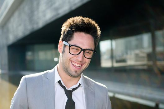 Portrait of a handsome young businessman laughing