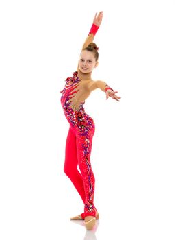 A gymnast girl prepares for the exercise. The concept of childhood and sport, a healthy lifestyle. Isolated on white background.