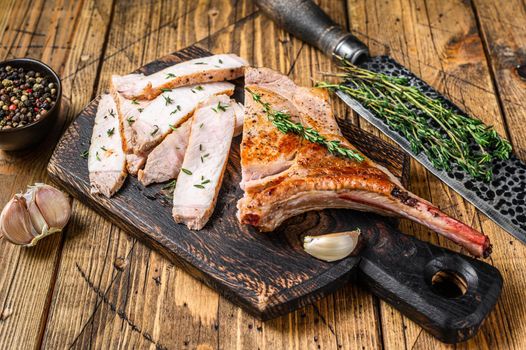 Sliced bbq rib pork chop meat steak. Wooden background. Top view.