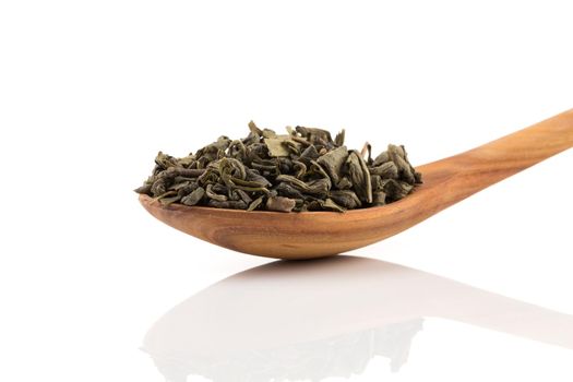 Gunpowder green tea in spoon isolated on a white background
