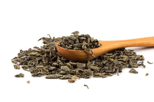 Gunpowder green tea in spoon isolated on a white background