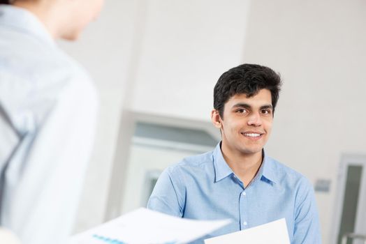 portrait of a young man at a business meeting. concept of team work