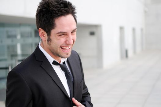 Portrait of a handsome young businessman laughing