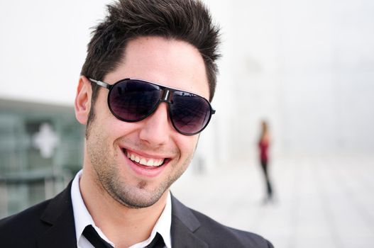 Portrait of a handsome young businessman laughing