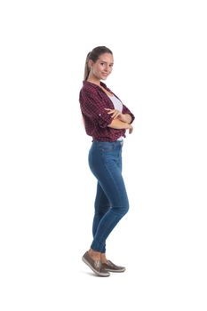 Smiling young casual woman standing with arms crossed full length portrait isolated on white background