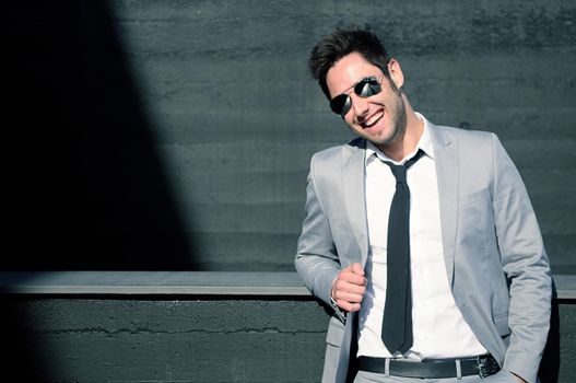 Portrait of a handsome young businessman laughing