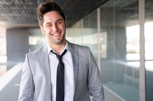Portrait of a handsome young businessman laughing
