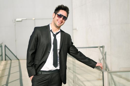 Portrait of a handsome young businessman smiling with sunglasses