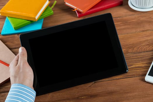 close-up of men's hands with a computer tablet. Businessman works in the office