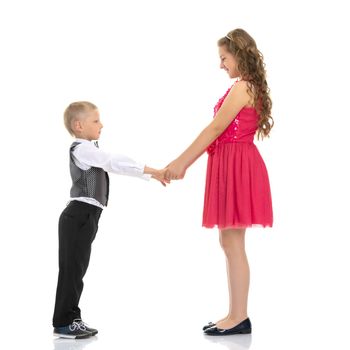 A boy and a girl are holding hands. The concept of friendship, happy childhood. Isolated on white background.