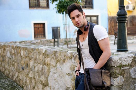 Portrait of young attractive man in urban background
