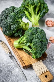 Raw green broccoli cabbage on a wooden cutting board. White background. Top view.