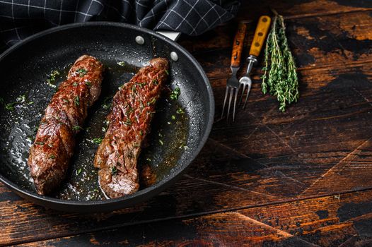 Grilled Skirt machete Steak in a pan. Dark wooden background. Top view. Copy space.