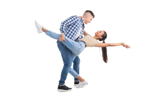 Young man and woman dancing tango and smiling isolated on white background