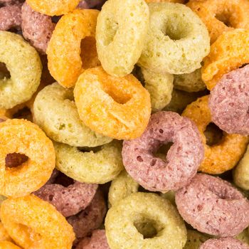 Close up image of colorful cereal against white background