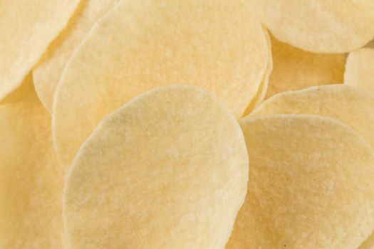Prepared potato chips snack closeup view on white background