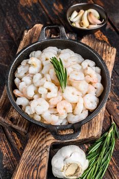 Boiled Peeled Shrimps, Prawns in a pan. Dark Wooden background. top view.