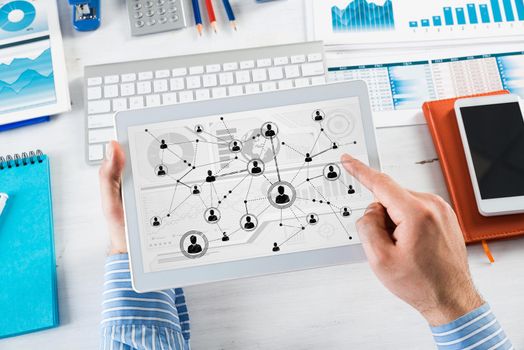 Men's hands hold a computer tablet. Social media concept