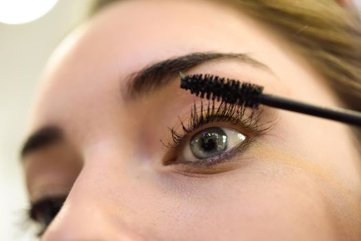 Makeup. Make-up. Applying Mascara. Long Eyelashes and blue eyes
