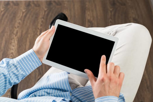close-up of men's hands with a computer tablet. Businessman works in the office
