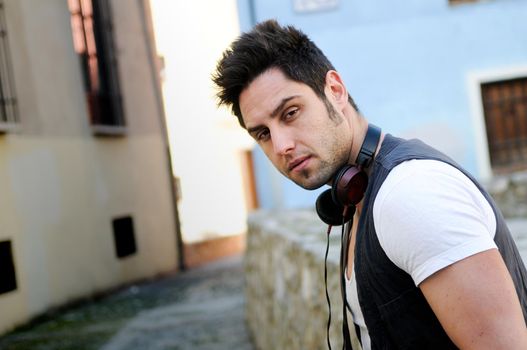 Portrait of young attractive man in urban background