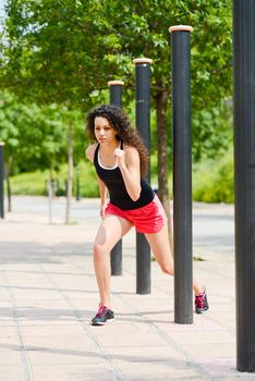 Portrait of young woman doing sports in the street