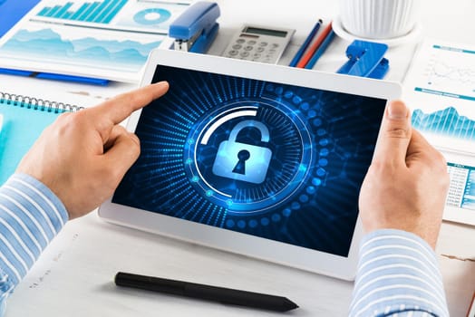close-up, male hands with tablet. Businessman working at the table in office. computer security concept